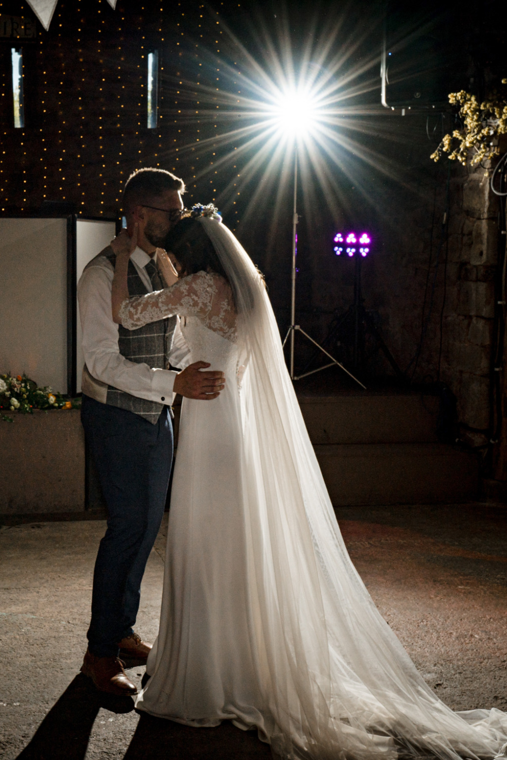 Bride and groom spotlight dancing on the dancefloor