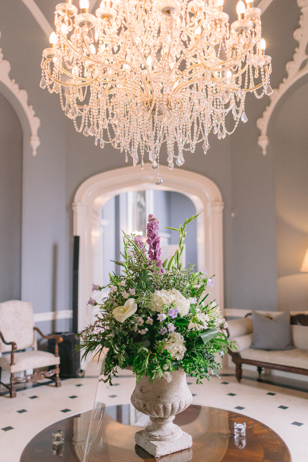 Bouquet in vase on top of table chandelier hanging